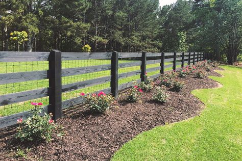 Farmhouse Fence Ideas Front Yards Metal, Ranch Style Wood Fence, Drive Way Fence Ideas, Farm Fence Landscaping, Black 3 Rail Wood Fence, Black Ranch Fencing, Fence Along Road, Stone And Wood Fence Ideas, Farmhouse Front Yard Fence