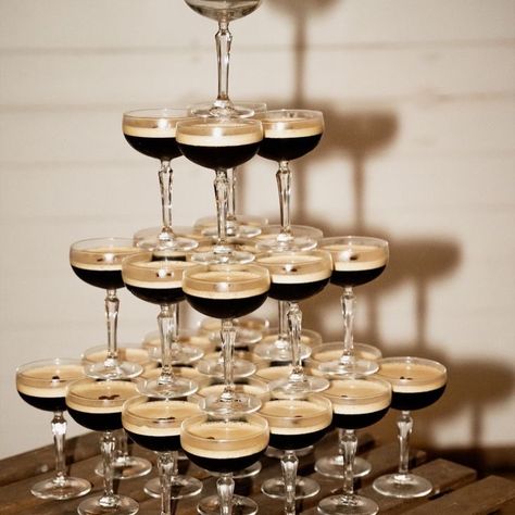 A more caffeinated version of your classic champagne tower, OH we love it!! Photography @lea.and.lensphotography Espresso Martini Wedding Drink, Espresso Martini Fountain, Espresso Martini At Wedding, Espresso Bar At Wedding, Love Is Brewing Bridal Shower Ideas Espresso Martini, Espresso Martini Bachelorette Party, Wedding Espresso Bar, Wedding Espresso Martini, Espresso Martini Tower Wedding