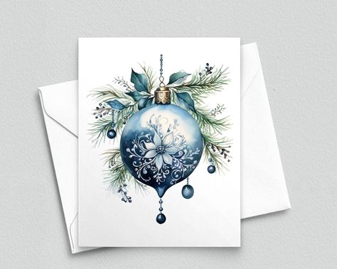 This exquisite note card features a beautifully crafted vintage light blue Christmas bulb adorned with delicate white stylized poinsettia motifs. Hanging from the bulb are elegant blue bauble drops, intertwined with lush greenery and whimsical blue berries. Perfect for sending warm holiday wishes with a touch of timeless charm and sophistication. Note cards are designed, printed and finished on site in our home studio. Each card is American standard A2 size (4.25 x 5.5 inches). Each card is prin Christmas Bauble Cards, Bauble Christmas Cards, Light Blue Christmas, Elegant Christmas Cards, Blue Baubles, Blue Berries, Beautiful Christmas Cards, Watercolor Christmas Cards, Christmas Card Crafts