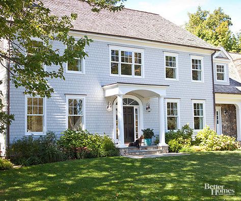 When many Colonial homes were constructed, builders used local materials on hand. For the East Coast, that often meant wood, and clapboard siding became a regular feature on this home type. Colonial Exterior Colors, Light Blue Houses, Grey Exterior House Colors, Colonial House Exteriors, Brick Siding, Clapboard Siding, House Shutters, Living Trust, Colonial Exterior