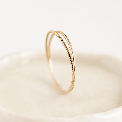 Two intertwined gold rings: a delicate braided band with a simple round-profile band. Double the fun! Simple Promise Rings Gold, Braided Gold Wedding Band, Minimalistic Gold Jewelry, Simple Gold Rings Everyday, Cute Gold Rings, Wedding Bands Simple, Simple Gold Rings, Simple Ring Design, Wedding Ring Simple