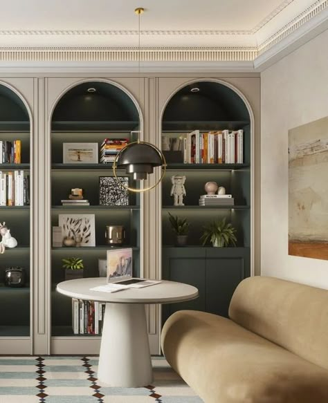 Picture of a sophisticated space with arched bookcases, dark green shelves and cabinets, books and lovely decor, a tan sofa and a round coffee table Green Arched Bookcase, Arched Library, Arched Kitchen Cabinets, Arch Shelves, Book Shelves Ideas, Arched Bookcases, Arched Shelving, Books Cabinet, Classical Office