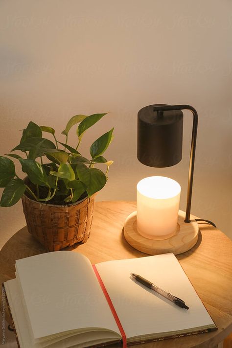 Candle warmer lamp, writing journal, and houseplant on side table in a clean modern cozy living room. Room Side Table, Candle Warmer Lamp, Modern Cozy Living Room, Writing Journal, Living Room Side Table, Candle Warmer, Clean Modern, Journal Writing, Cozy Living