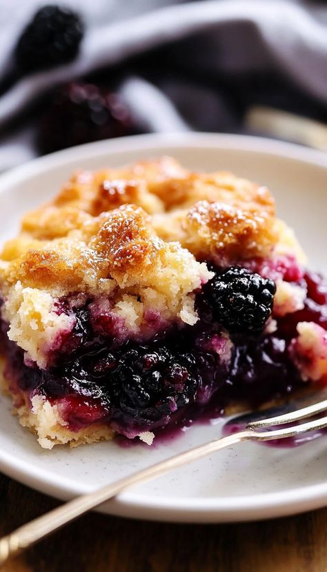 This blackberry cobbler brings together the natural sweetness of fresh blackberries and a golden, buttery crust. With just a few simple ingredients, this dessert is quick to prepare yet delivers an explosion of flavor. The bubbling fruit filling and tender biscuit topping pair beautifully with a scoop of vanilla ice cream or a dollop of whipped cream. Whether served warm or at room temperature, it’s a dessert that captures the essence of homemade goodness. Blackberry Raspberry Cobbler, Blackberry Doobie Recipe, Blackberry Baking Recipes, Quick Blackberry Cobbler, Apple Berry Cobbler, Marion Berry Cobbler, Bubble Up Dessert Recipes, Best Cobbler Crust, Cast Iron Blackberry Cobbler