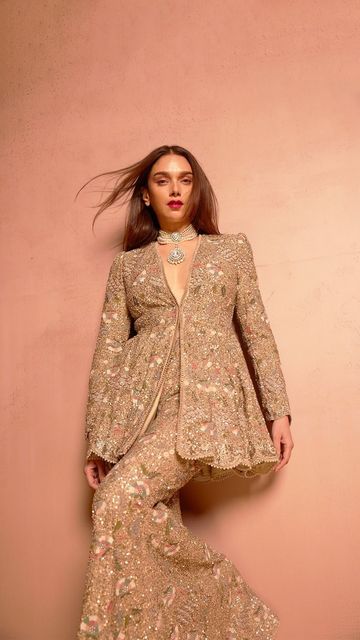 Jayanti Reddy on Instagram: "Our quintessential muse @aditiraohydari graces us in a hand-embroidered peplum and sharara, resplendent in gold sequins and intricate threadwork. A masterpiece of craftsmanship, meticulous detail, culminating in a timeless and dreamy finish.  #JayantiReddyCouture" Sharara New Designs, Peplum Indian Outfit, Peplum Suits Indian, Party Wear Indian Dresses Receptions, Indian Dresses To Wear To A Wedding, Indo Western Party Wear Women, Embellished Sharara For Reception And Transitional Season, Elegant Festive Peplum Sharara, Outfit For Indian Wedding