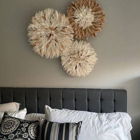 Set of 3 juju hats wall decor hanging above head bed. The feather hats have 3 sizes with the 60cm in speckled brown and white, the 50cm in brown with white center, and the 40cm all white. The head bed is black and has black and white upholstery pillows Juju Hat Decor, Hat Decor, Hat Wall, Juju Hat, Modern Buffet, Above Couch, Above Bed Decor, Interior Wall Decor, Interior Wall Design