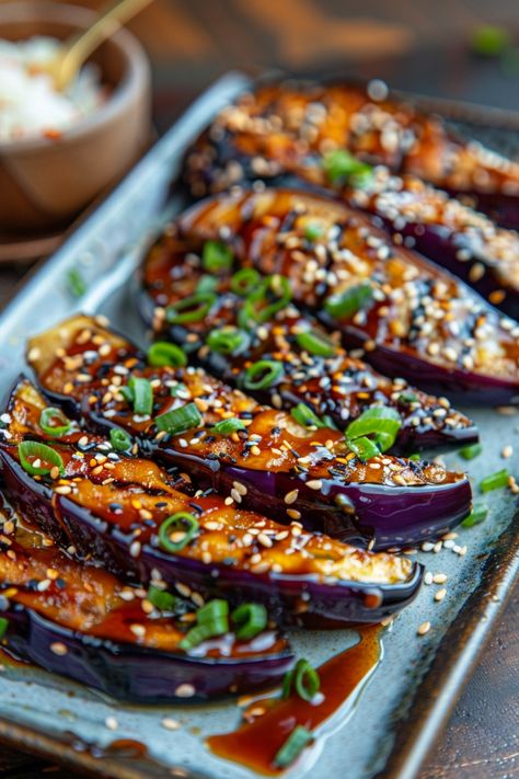 Roasted eggplant topped with sesame seeds, chopped green onions, and a savory sauce on a ceramic plate. Miso Glazed Aubergine, Japanese Side Salad, Miso Glazed Eggplant Recipe, Miso Eggplant Japanese, Japanese Veggie Side Dish, Japanese Vegetable Dishes, Purple Salad Recipes, Oi Muchim Recipe, Eggplant Miso Recipe