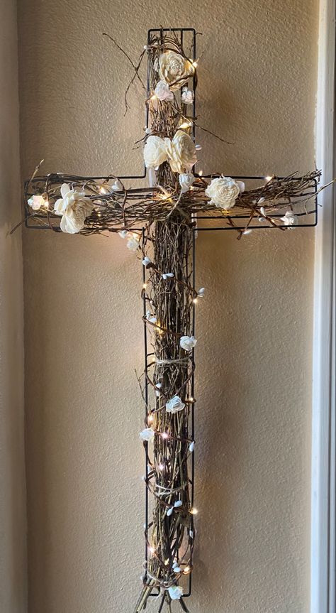 Metal cross with twine, wood flowers, wrapped with lighted copper wire with flowers. In colors/shades of whites, greens and browns. 24”high 12” wide, 2” deep How To Decorate A Wire Cross From Dollar Tree, Wire Crosses Diy How To Make, Dollar Tree Wire Cross Wreath Diy, Wire Crosses Diy, Diy Cross Decor, Wreaths For Funerals, Cross Wreath Diy, Wooden Cross Crafts, Grass Valley California