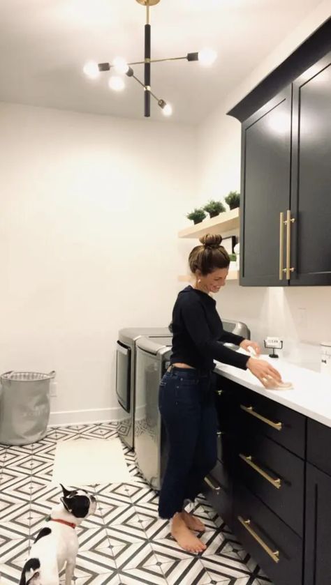 Laundry Room Next To Garage Door, Lvp Laundry Room, Laundry Room Ideas Black Cabinets, Laundry Room Black Tile Floor, Black White And Gold Laundry Room, Laundry Room With Black And White Tile, Black Cabinet Laundry Room Ideas, Black Laundry Cabinets, Iron Ore Laundry Room Cabinets