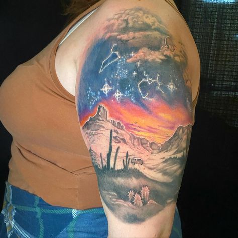 We are in love with this tattoo that @sydneyctattoo did in colour/black and grey! This piece depicts a canyon/desert scene, with a car driving on a trip, and zodiac signs in the sunset coloured sky! Sydney perfectly captured a warm evening, with the orange, pinks, and yellows of the sky, fading to blue. Desert Scene Tattoo, Canyon Tattoo, Night Sky Tattoos, Waterfall Tattoo, Desert Tattoo, Sky Tattoo, Sky Tattoos, Night Tattoo, Scene Tattoo