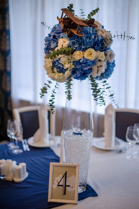 centerpiece. airplane. flowers. Aviation Themed Centerpieces, Airplane Table Centerpiece, Aviation Centerpieces, Plane Centerpiece, Airplane Centerpieces, Airplane Centerpiece Ideas, Pilot Wedding, Classroom Ceiling, Hangar Wedding