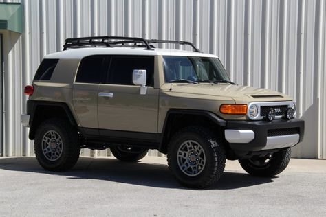 This 2012 Toyota FJ Cruiser was first sold by Coggin Toyota in Jacksonville, Florida, and remained in the state with two owners prior to its acquisition by the selling dealer in April 2020. The truck is finished in beige with a white roof over a black cloth interior, and power comes from a 4.0-liter V6 paired with a six-speed manual transmission and a dual-range transfer case. Features include a roof rack, side steps, a JBL stereo, and a clinometer/tilt indicator as well as modifications such as Fj Cruiser Interior, 2007 Toyota Fj Cruiser, 2014 Toyota Fj Cruiser, Toyota Suv, Window Tint Film, Flashy Cars, Used Toyota, All Terrain Tyres, Toyota Fj Cruiser