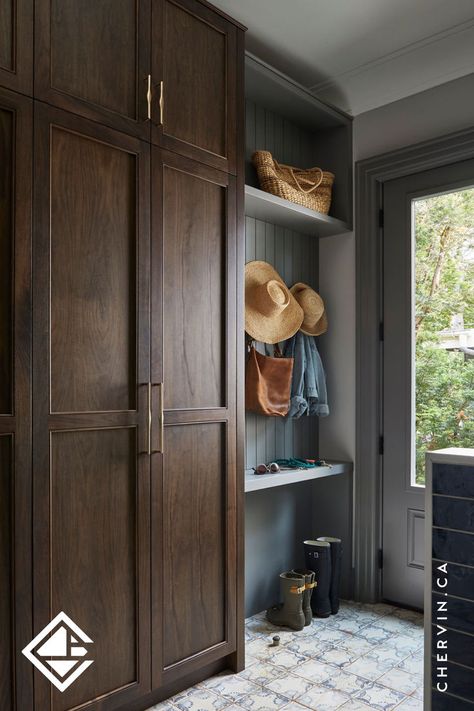 A stylish mudroom with tall walnut cabinets and grey accents. Elegant Mudroom, Shelf For Keys, Organized Mudroom, Stained Wood Cabinets, Mudroom Inspiration, Mudroom Cabinets, Mudroom Design, Walnut Cabinets, Room Goals