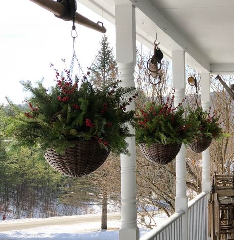 Front Porch Hanging Baskets Winter, Christmas Outdoor Hanging Baskets, Hanging Winter Baskets, Hanging Basket Christmas Decoration, Winter Wheelbarrow Decor, Hanging Christmas Baskets Front Porches, Winter Hanging Baskets Outdoor Diy, Winter Hanging Basket, Outdoor Christmas Hanging Baskets