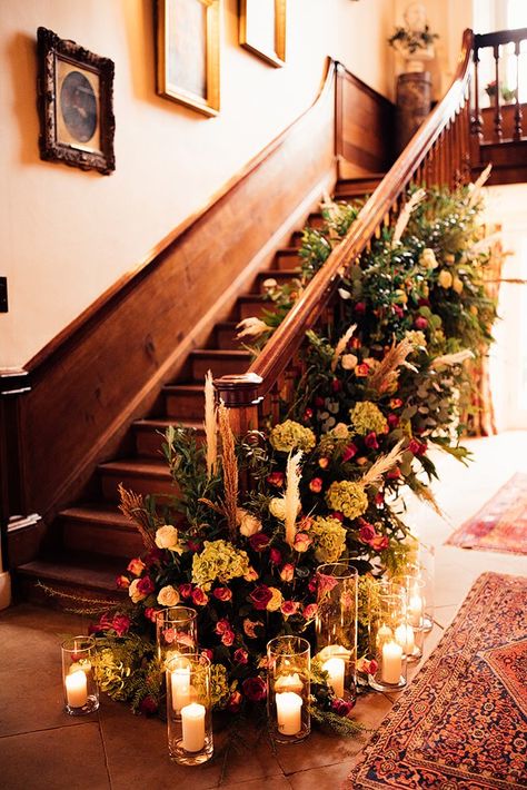 Candles On Staircase, Wedding Florals On Staircase, Flowers Staircase, Wedding Dress For Winter, Dress For Winter Wedding, Wedding Flower Display, Stairs Floral Decor Wedding, Floral Bannister Wedding, Staircase Flowers Wedding Banisters