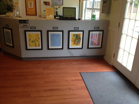 Simple frames highlight and honor children's open-ended artwork in Sunshine House 91's lobby in Marietta, GA Daycare Director Office Ideas, Childcare Front Entrance Ideas, Childcare Lobby Ideas, Daycare Lobby Ideas Reception Areas, Preschool Lobby, Preschool Office, Childcare Center Lobby, Preschool Director Office, Preschool Lobby Decor Ideas