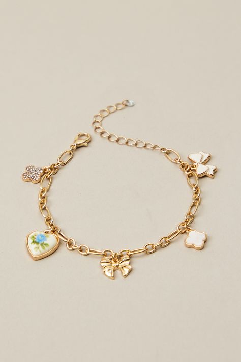 This charm bracelet features a dainty floral heart and bow pendant that will add a sweet touch of elegance to any outfit. Altered State Jewelry, Multi Charm Bracelet, Charm Friendship Bracelet, Christmas Wishlist Ideas Aesthetic, Dainty Charm Bracelet, Christmas Charm Bracelet, Charm Bracelet Ideas, Cute Charm Bracelets, Charm Bracelet Aesthetic