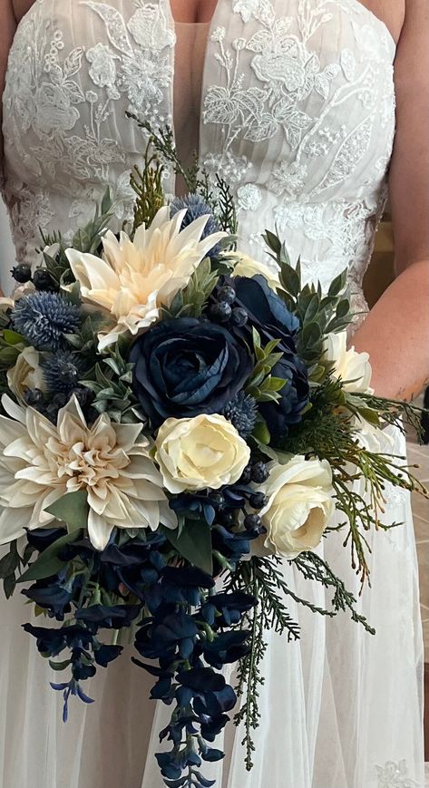 CONGRATULATIONS on your upcoming wedding! This beautiful silk flower bridal bouquet is a romantic inspired blue and ivory bouquet made with a stunning mix of faux/artificial flowers. Gorgeous greenery completes the look and all stems are flawlessly wrapped in ribbon of your color choice. Bouquet measures approx. 14"in diameter by 18" in length (although other diameters are available in drop down menu). Shown here tied with ribbon, but if you are interested in luxurious silk ribbon, this is available for an extra charge. If interested, please message us with the ribbon color you would like.  Matching wedding flowers are also available, so please ask us about a full wedding flower package including bridesmaid bouquets, boutonnieres, corsages and hair wreaths. Your order will be packaged secu Blue Wedding Ideas Decoration, Dark Blue And White Wedding Theme, Navy Blue Flowers Bouquet, Royal Blue And White Bouquet, Dark Blue Wedding Flowers, Royal Blue And Silver Wedding Theme, Black White And Blue Wedding, Navy Flower Bouquet, Bridesmaid Bouquet Blue