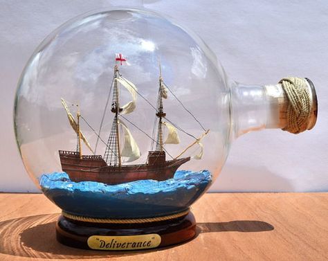 A hand sculpted miniature model of the Deliverance of 1609 displayed inside a unique and large, round-bottomed flask. Bottle Ship, Boat In A Bottle, Inktober Ideas, Pirate Bedroom, Ship In Bottle, Explorer Yacht, Uss Constitution, Bottle Drawing, Nautical Inspiration