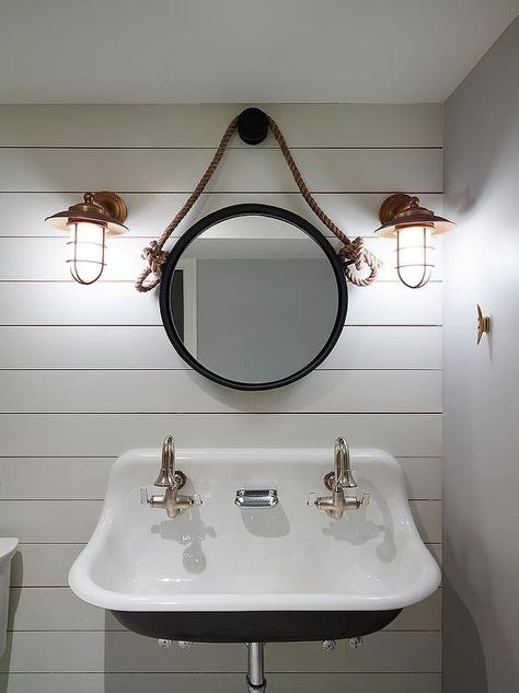 Nautical boy's bathroom features a shiplap clad accent wall lined with a Kohler Brockway Sink fitted with two gooseneck faucets under a rope hung mirror, Restoration Hardware iron & Rope Mirror, illuminated by copper cage sconces. Nautical Interior Design, Nautical Bathroom Design Ideas, Classic Bathroom Design, Nautical Interior, Beach House Bathroom, Shiplap Bathroom, Nautical Bathroom Decor, Cottage Bathroom, Nautical Bathrooms