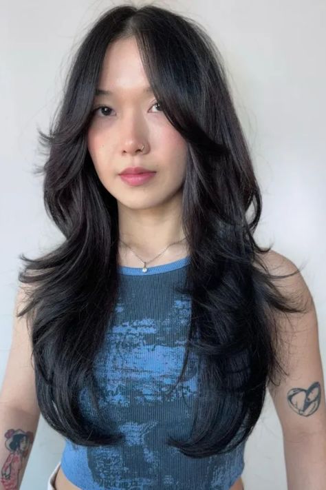 Person with long, layered black hair and tattoos on arms, wearing a blue tank top. Wolf Cut Girls Long Hair, Mid Length Wolf Cut Straight Hair, Wolf Cut Hair Styling, Wolfcut Mid Length, Wolf Cut On Straight Hair, Wolf Tail Haircut, The Wolf Cut Hair, Wolf Cut Short, Unique Hair Color Ideas