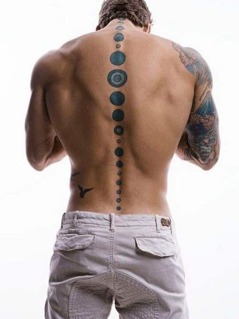 The blue small circles give the spine a sleek look. They don't overcrowd the back and the owner can choose to add more tattoos later on as there is plenty of room for more. Meanwhile this one frames his spine nicely. #tattoofriday #tattoos #tattooart #tattoodesign #tattooidea Tattoos Arm Mann, Tattoo Quotes For Men, Tattoo Trend, Wolf Tattoo Design, Back Tattoos For Guys, Spine Tattoo, Tattoo Feminina, Spine Tattoos, Unique Tattoo