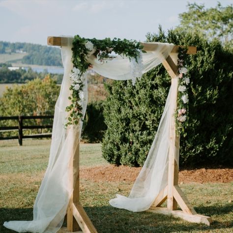 A simple wooden structure made elegant with tule and floral arrangements. This wedding arch made for a beautiful accessory to our bride and groom but did not take away from the natural beauty of the Blue Ridge Mountains.

Photographer: Mary Catherine Photography
Venue: @wolftrapfarm in Charlottesville, Virginia
Planner: Details and Lace Simple Wood Arch Wedding, Wood Ceremony Arch, Wooden Arch Wedding Decor, Simple Rustic Wedding Arch, Diy Simple Wedding Arch, Natural Wood Wedding Arch, Wooden Wedding Arbor, Wooden Arch With Flowers, Minimalistic Wedding Arch