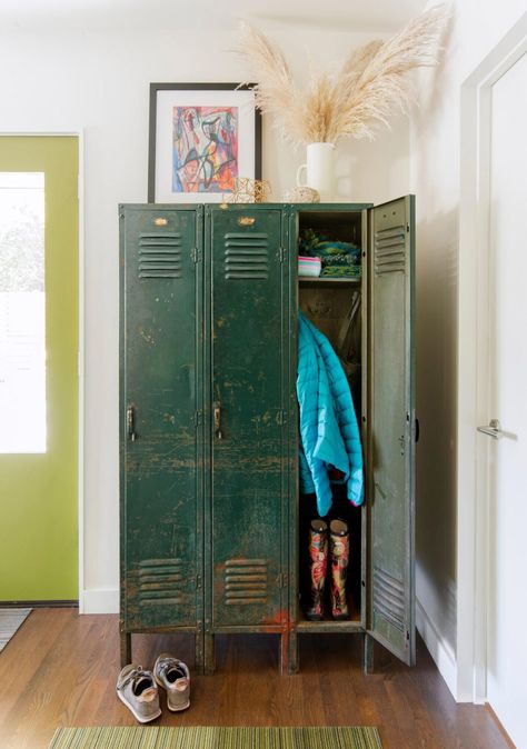 Blues, greens and warm dollops of orange ripple through the home—in art, textiles and even on the mudroom door, painted in Benjamin Moore's Dark Celery. Industrial Art Studio, Mudroom Door, Entry Way Lockers, Mudroom Inspiration, Ranch Renovation, Sleek Fireplace, Vintage Lockers, Midwest Living, Art Textiles