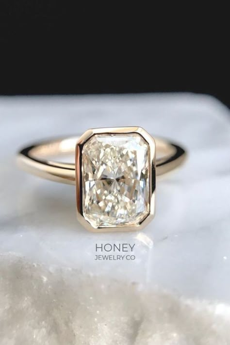 A fan favorite custom engagement ring by Honey Jewelry Co. This ring features a beautiful radiant cut diamond surrounded by just the right amount of gold. Honey Jewelry, Bezel Set Engagement Ring, Elegant Engagement Rings, Engagement Ring Rose Gold, Custom Wedding Rings, Classic Engagement Rings, Blue Nile, Vintage Engagement, Sapphire Engagement