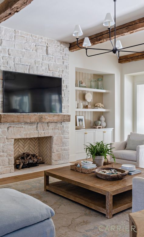 EASY, BREEZY LOUNGING IN THIS COASTAL LIVING ROOM designed by Carrier Design Co. - Photography by Muriel Silva Photography Living Room Designs With Stone Fireplace, Living Room Fireplace Designs, Coastal Home Living Room, Coastal Cottage Fireplace, Tv Above Fireplace 8ft Ceiling, Exposed Beam Living Room, Coastal Farmhouse Family Room, Moody Coastal Living Room, Coastal Farmhouse Fireplace