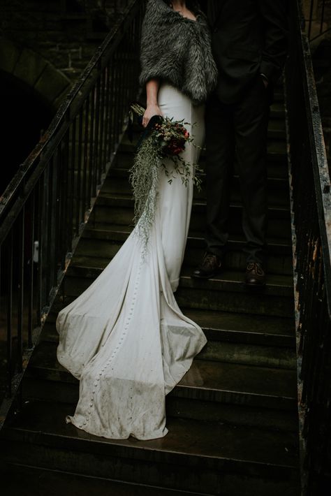 Darkness meets romance in this moody Edinburgh wedding, complete with faux fur, leather jackets, and a wet and dirty dress train Dark Winter Wedding Dress, Winter Forest Wedding Aesthetic, Winter Wedding Scotland, Dark And Moody Wedding Dress, Scottish Winter Wedding, Nordic Wedding Dress, Dark Academia Wedding Dress, Dark Winter Wedding, Skyrim Wedding