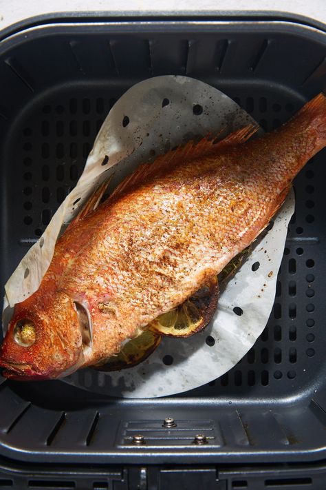 The cooked whole fish in the air fryer basket. Whole Sea Bass Recipes, Whole Fish Fry Recipe, Whole Snapper Recipes, Whole Trout Recipes, Fish In The Air Fryer, Ackee And Saltfish Recipe, Air Fry Fish Recipe, Whole Tilapia, Fried Whole Fish