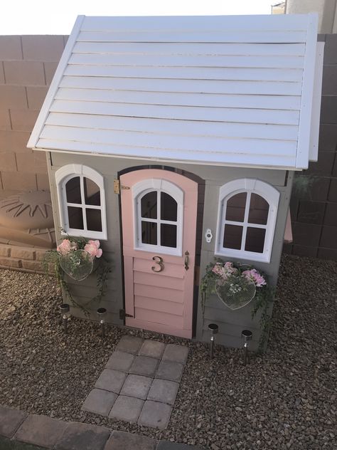 DIY painting project for my daughters playhouse. Came in cedar wood and painted with 3 colors: Pink, Grey & White. Added heart mesh metal flower boxes with silk peonies and artificial vines. Walkway is with 3x3 paver bricks. Playhouse Paint Ideas, Outdoor Playhouse Makeover, Playhouse Redo, Playhouse Inspiration, Playhouse Remodel, Playhouses For Kids, Pink Playhouse, Wooden Outdoor Playhouse, Outdoor Playhouses