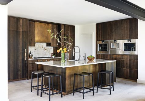 The traditional kitchen in designer Jan Mengenhauser’s otherwise contemporary Reston home was a renovation waiting to happen. An awkward bank of cabinets cramped the dining area and blocked garden views across the adjacent family room. After tolerating the space for 23 years, she relates, “I finally pulled the trigger.”  Mengenhauser… Floating Bar Shelves, System Furniture, Bronze Kitchen, Home Design Magazines, Stone Backsplash, Kitchen Installation, Brass Kitchen, Custom Kitchens, Metal Kitchen