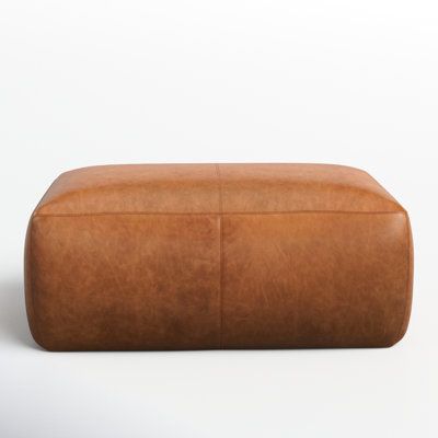 This hustle 43" wide genuine leather rectangle cocktail ottoman infuses loads of rustic yet contemporary allure for your space as a footrest, extra seating, or even as a coffee table when you place a tray on top. Crafted of Italian leather, this piece is minimally processed to bring out the hide’s authentic character, natural bumps, and all, lending a handsome patina through the years. Featuring a kiln-dried rubberwood frame that’s corner-blocked with reinforced joinery, it offers robust constru Ottoman Leather, Leather Wingback Chair, Square Pouf Ottoman, Leather Wingback, Rectangle Ottoman, Dimensional Wall Art, Square Pouf, Swivel Barrel Chair, Modern Living Room Furniture