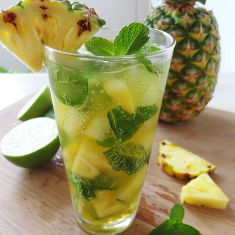 Pineapple Mint Mojito (Non-Alcoholic) Ingredients: 1/2 cup fresh pineapple chunks 10 fresh mint leaves, plus extra for garnish 1 tablespoon sugar (optional) 1 lime, cut into wedges 1/2 cup pineapple juice 1 cup sparkling water or club soda Ice cubes Pineapple slices, for garnish Instructions: Prepare the Mojito: Muddle the Ingredients: In a sturdy glass or cocktail shaker, combine the fresh pineapple chunks, mint leaves, and sugar. Use a muddler or the back of a spoon to gently mash the ingre... Pineapple Mint, Pineapple Chunks, Mint Mojito, Pineapple Slices, Fresh Pineapple, Fresh Mint Leaves, Club Soda, Sparkling Water, Cocktail Shaker