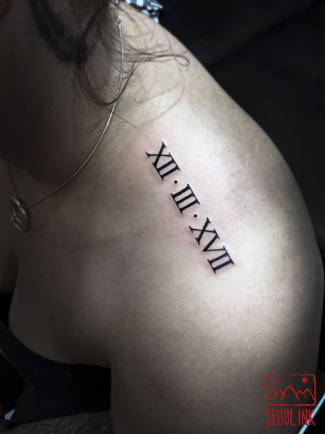 Roman Numerals Shoulder Tattoo, Shoulder Tattoo Roman Numerals, Shoulder Roman Numeral Tattoo, Roman Numeral Tattoos For Women, Greek Numbers Tattoo, Tattoos For Women Roman Numerals, Birthdate Tattoo Ideas Roman Numerals, Back Shoulder Tattoos For Women, Back Shoulder Tattoos