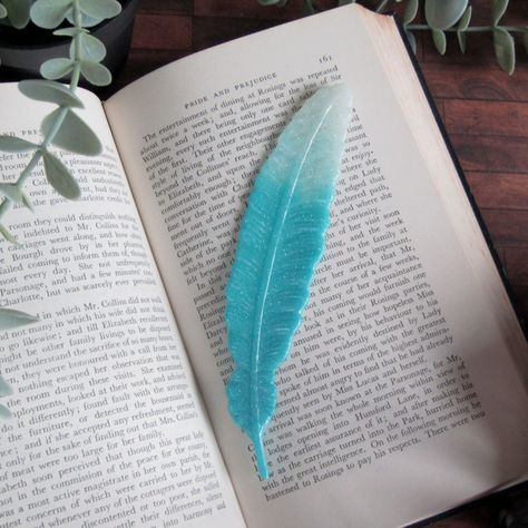 Resin Bookmarks for the book addict 😍 #indigomoon #indigomoonstudiouk #bookmark #resin #feather #bookworm #bookaddict Bookmark Resin, Resin Bookmarks, Feather Bookmark, Book Enthusiast, Book Art Diy, Gift For Sister, Gifts For Bookworms, Feather Design, Mica Powder