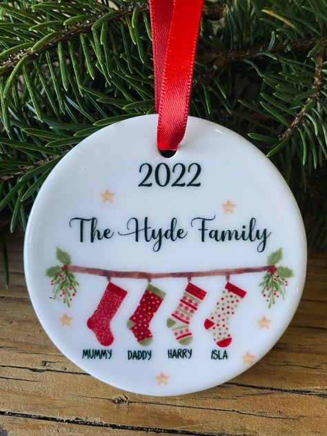 Family Christmas 2022 bauble/ tree ornament A beautiful keepsake ceramic bauble made to order. Beautiful festive stocking print personalised with your choice of name/names - up to 6 stockings per bauble * Flat bauble, Approx 7cm in diameter, approx 3mm thick. * Double sided print - finished with red effect ribbon. Comes with velvet effect gift pouch. A truly lovely keepsake gift. Hanging Tree, Bauble Ornaments, Pottery Inspiration, Family Decor, Xmas Presents, Christmas 2022, Uv Print, Christmas 2023, Gift Pouch