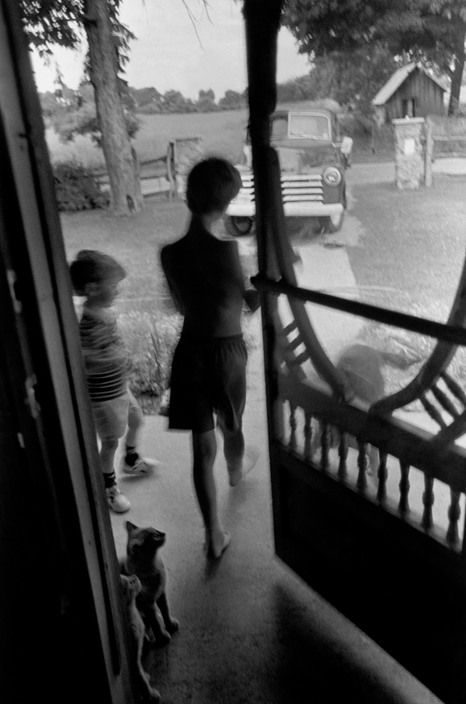 Larry Towell. CANADA. Lambton County, Ontario. 1997. Noah and Isaac TOWELL exit the house through the front door. Pet dog (Banjo) and cats wait to be fed. Larry Towell, Standing Rock, Magnum Photos, Photography Workshops, Long Exposure, White Photo, Banjo, Pet Dog, Photography Inspiration