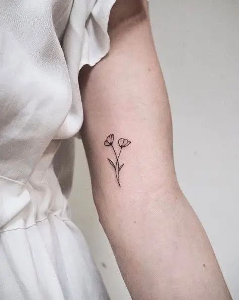 The Best 32 Bicep Tattoo For Women Every Artist Approves - Psycho Tats Inner Bicep Tattoo Women Flower, Under Bicep Tattoo Women, Tattoo Bicep Women, Lower Bicep Tattoo Women, Small Bicep Tattoo, Biceps Tattoo For Women, Small Bicep Tattoos For Women, Upper Bicep Tattoo Women, Womens Bicep Tattoo