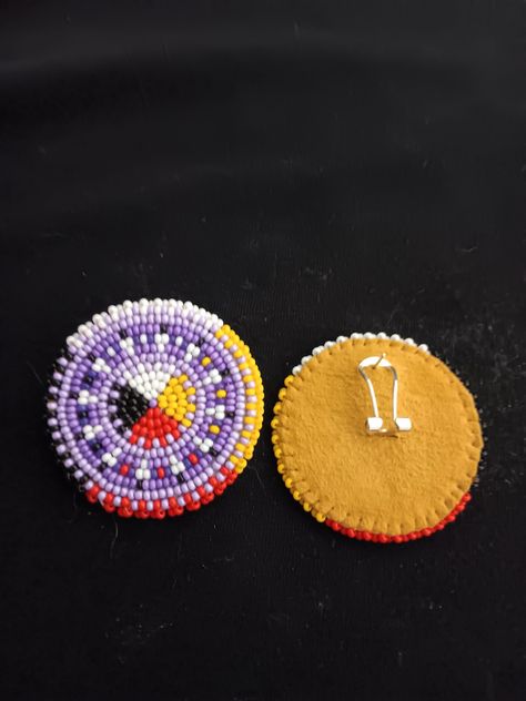 Beautiful colors of purple with feathers surrounded by a medicine wheel background they are 1.5 inches round and are backed with buckskin Native American Beaded Earrings, Medicine Wheel, Native American Crafts, Native Style, Handmade Earrings Beaded, Native American Beading, Beaded Earrings Patterns, Bead Work Jewelry, Beading Projects