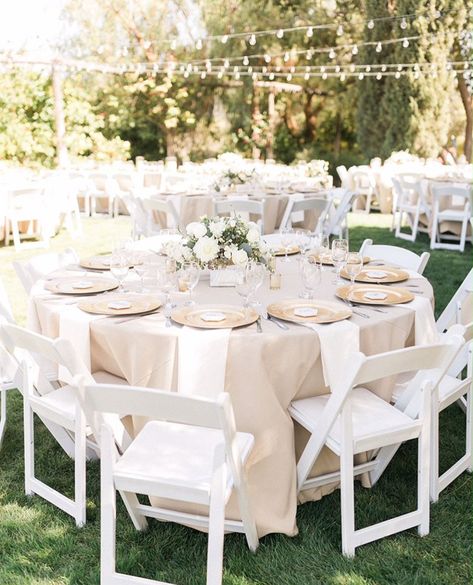 Outdoor Wedding Circle Tables, Wedding With White Chairs, White And Champagne Wedding Table, Ivory Table Cloth Wedding, Neutral Tablecloth Wedding, Wedding Table And Chairs, Ivory Round Table Wedding, Garden Party Round Tables, Ivory Table Cloth Wedding Setting