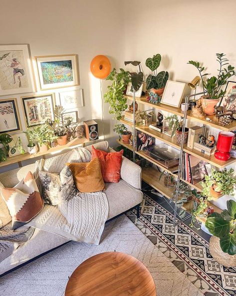 15 Plant Shelf Ideas We Love to Show Off Your Greenery Indoor Garden Shelves, Studio Apartment With Plants, Plant Shelf Behind Couch, Living Room Plant Wall, Bookshelves Plants, Shelf Behind Couch, Plant Shelf Ideas, Plant Decor Living Room, Indoor Plant Shelves