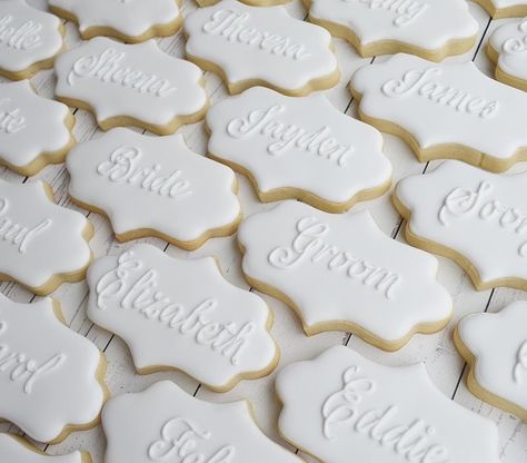 Veronica McMaster | 🍪Decorator on Instagram: “White on white wedding place card cookies ⚪️⚪️⚪️. How I adored making these!  #sugarcookies #royalicing #royalicingcookies…” Wedding Biscuit Place Names, Wedding Name Cookies, Cookie Place Cards Wedding, Cookie Name Place Cards, Placecard Cookies, Wedding Sugar Cookies Decorated, Cookie Place Cards, Place Card Cookies, Name Cookies