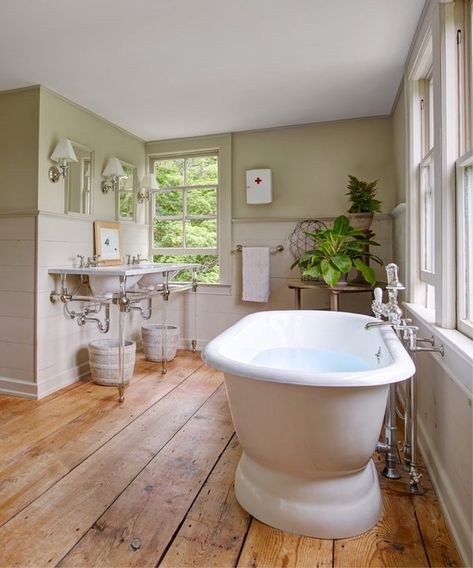 The wide floor planks in the master bath were salvaged from the original kitchen and sanded with a clear wax finish. A soaking tub from Waterworks anchors the room | archdigest.com Wood Floor Bathroom, Wood Floor Kitchen, Dream Farm, Bad Inspiration, Set Sofa, Country Bathroom, Gothic Revival, Master Bed, Wood Bathroom