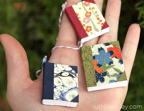 Tiny books to use to make napkin rings or what? Handful of handmade book Christmas tree ornaments by Ruth Bleakley Miniature Book Ornaments, Diy Book Ornaments Craft Ideas, Tiny Book Ornament Diy, Book Themed Ornaments Diy, Book Themed Ornaments, Diy Mini Book Ornament, Book Theme Christmas Tree, Mini Book Ornaments Diy, Diy Book Ornaments