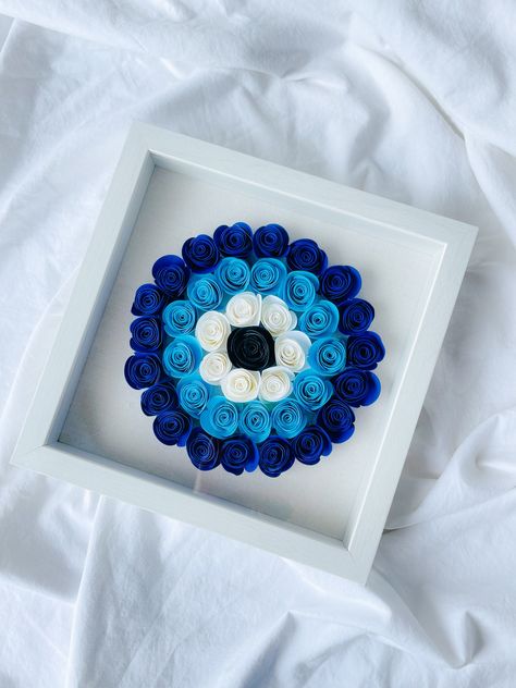 Evil Eye Design Shadow Boxes These cute shadow boxes come with hand-rolled flowers, and it comes with evil eye design for good luck! The frame is white.  Make perfect anniversary gifts or baby shower gifts. Can be customized to any design you would like. Thank you for supporting my small business! Connect with me on Instagram: @amidabyzaa  Thank you for visiting my shop!~ Zaa Evil Eye Cricut Projects, Evil Eye Gift Ideas, Evil Eye Gifts, Evil Eye Crafts Diy, Evil Eye Crafts, Evil Eye Craft, Evil Eye Flowers, Evil Eye Svg, Evil Eye Decor