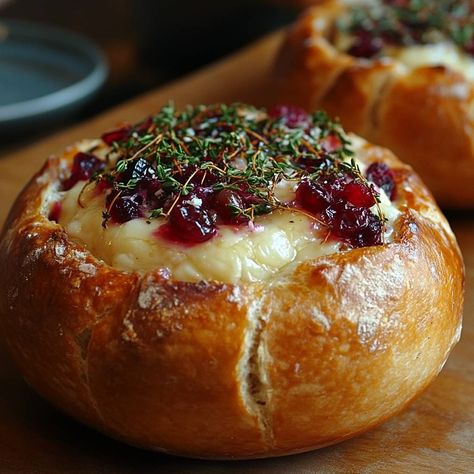 Warm Cranberry and Thyme Brie Bread Bowl Delight Introduction Warm Cranberry and Thyme Brie Bread Bowl Delight is a simple and delicious appetizer. It combines creamy brie cheese with tart cranberry sauce and fresh thyme, all served in a tasty sourdough bread bowl. This dish is perfect for gatherings or cozy nights at home. Why Baked Brie Bowl Recipe, Baked Brie Bread With Autumn Salad, Sourdough Bread With Brie And Cranberry, Christmas Candy Bowls, Brie And Sourdough Bread, Cheese Bowls Edible, Brie Sourdough Bowl, Baked Brie Bread Bowl With Jam, Sourdough Cranberry Brie