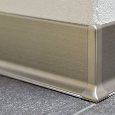 A New Type of Baseboard for Tiled Floors | schluter.com Home Baseboard Ideas, Garage Baseboard Ideas, Baseboard Alternative Ideas, Baseboard Alternative, Baseboard Replacement, Bathroom Baseboard Ideas, Flush Skirting, Metal Baseboard, Skirting Detail